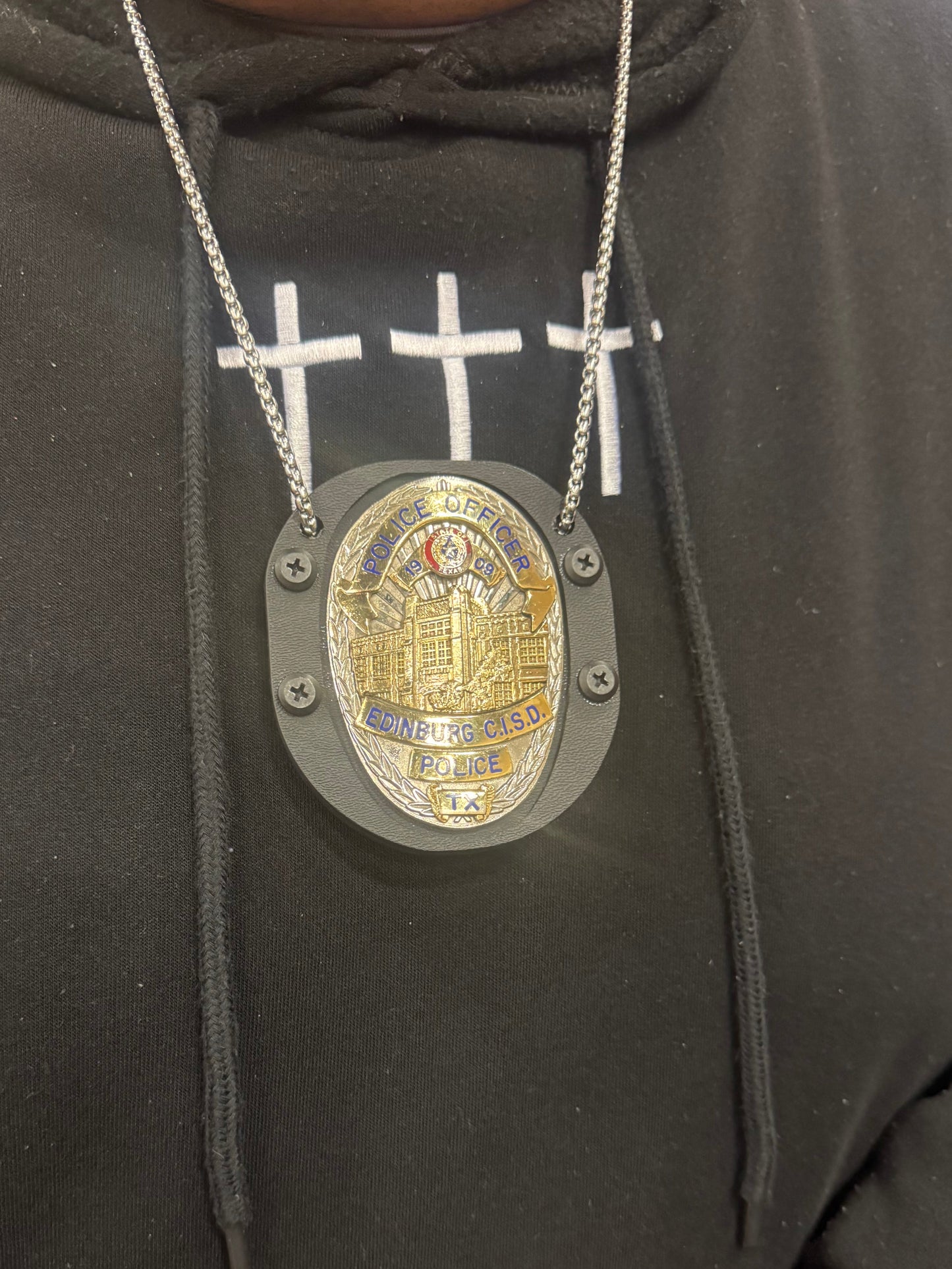 This officer asked us to drill 2 holes so he can wear it at court. The belt clip is still attached and he removes the chain when worn on the belt 