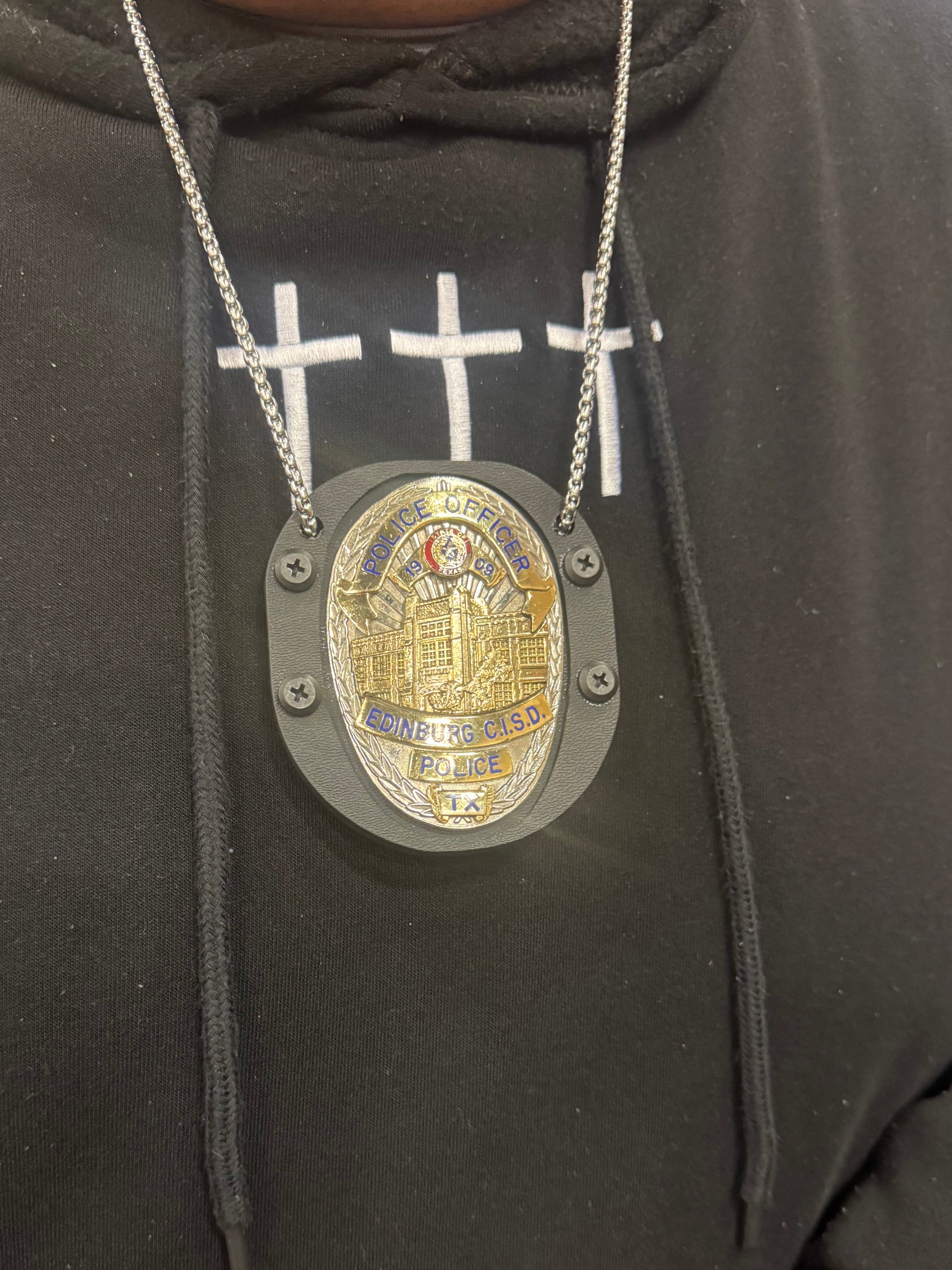 This officer asked us to drill 2 holes so he can wear it at court. The belt clip is still attached and he removes the chain when worn on the belt 